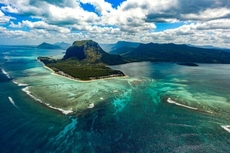 green island in the middle of body of water